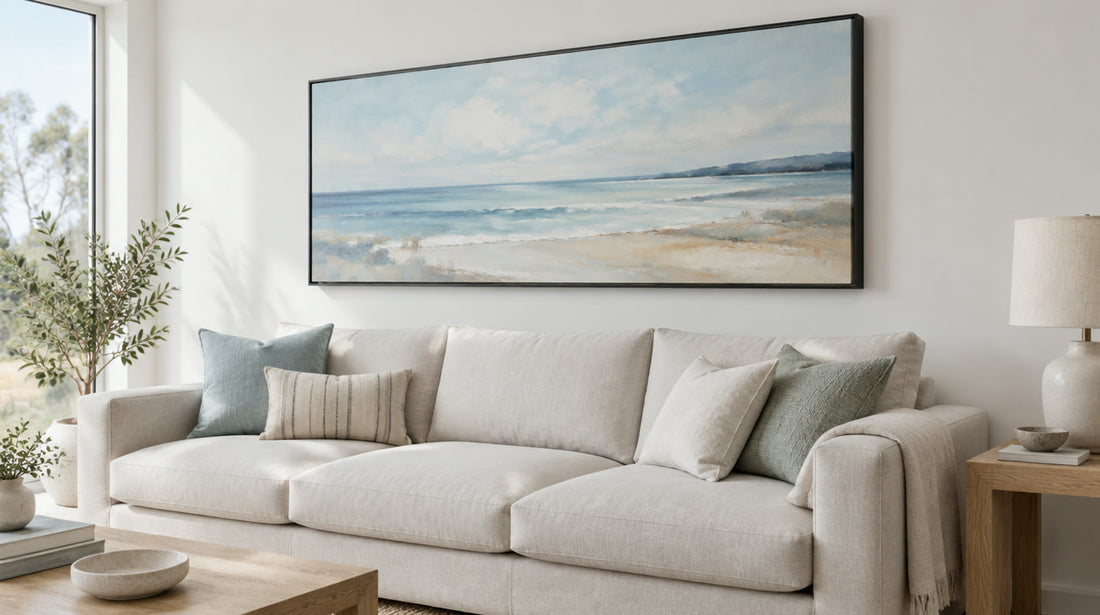 Abstract seascape painting in a black floating frame above a pale linen sofa in a light Australian living room, digitally styled room