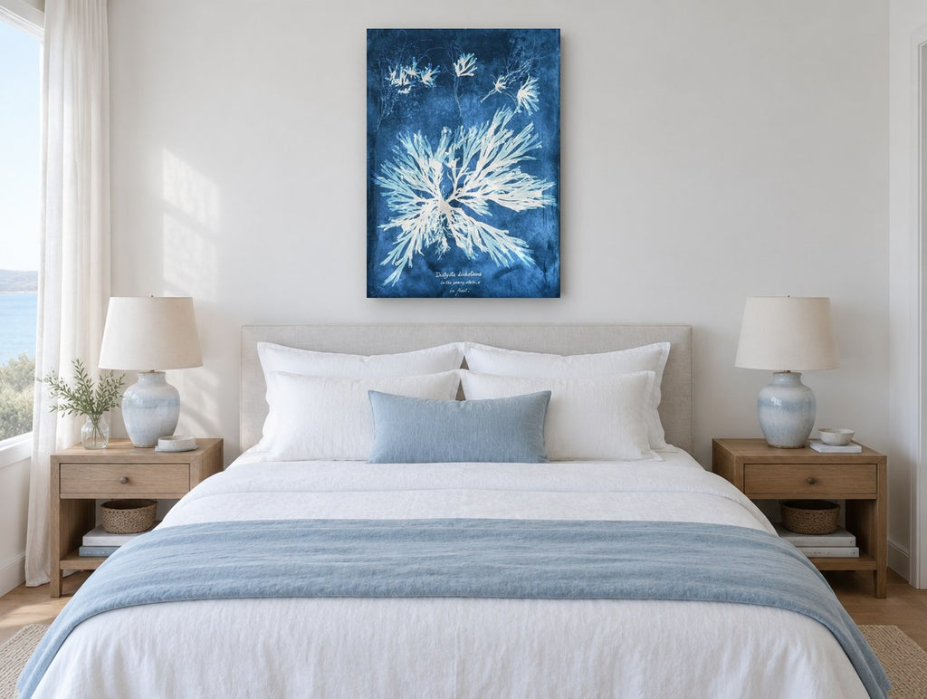 Indigo Seaweed Frond Burst vintage canvas print on the wall of a coastal bedroom