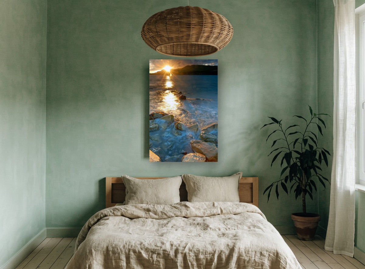 Sunburst Over Rocky Shallows coastal canvas print on the wall of a bedroom