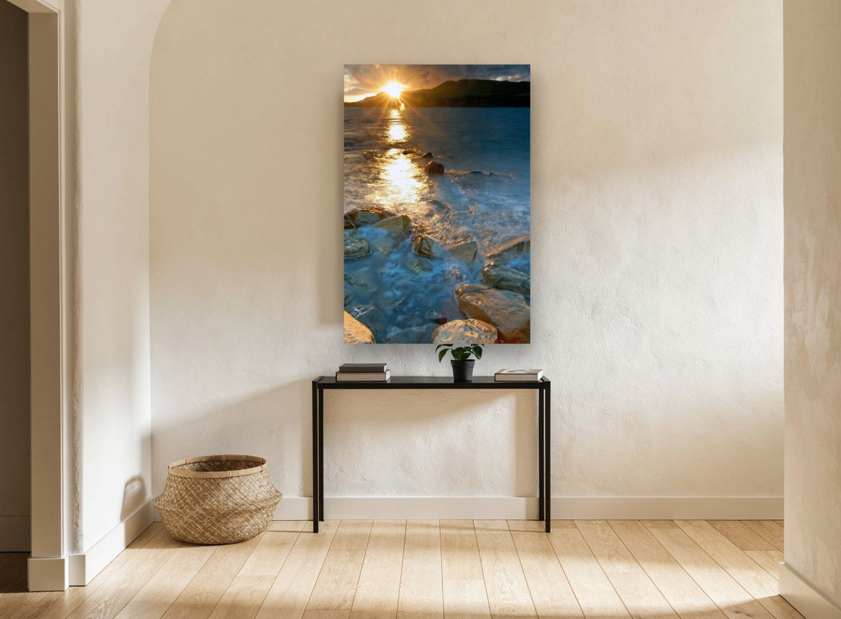 Sunburst Over Rocky Shallows coastal canvas print on the wall of a hallway