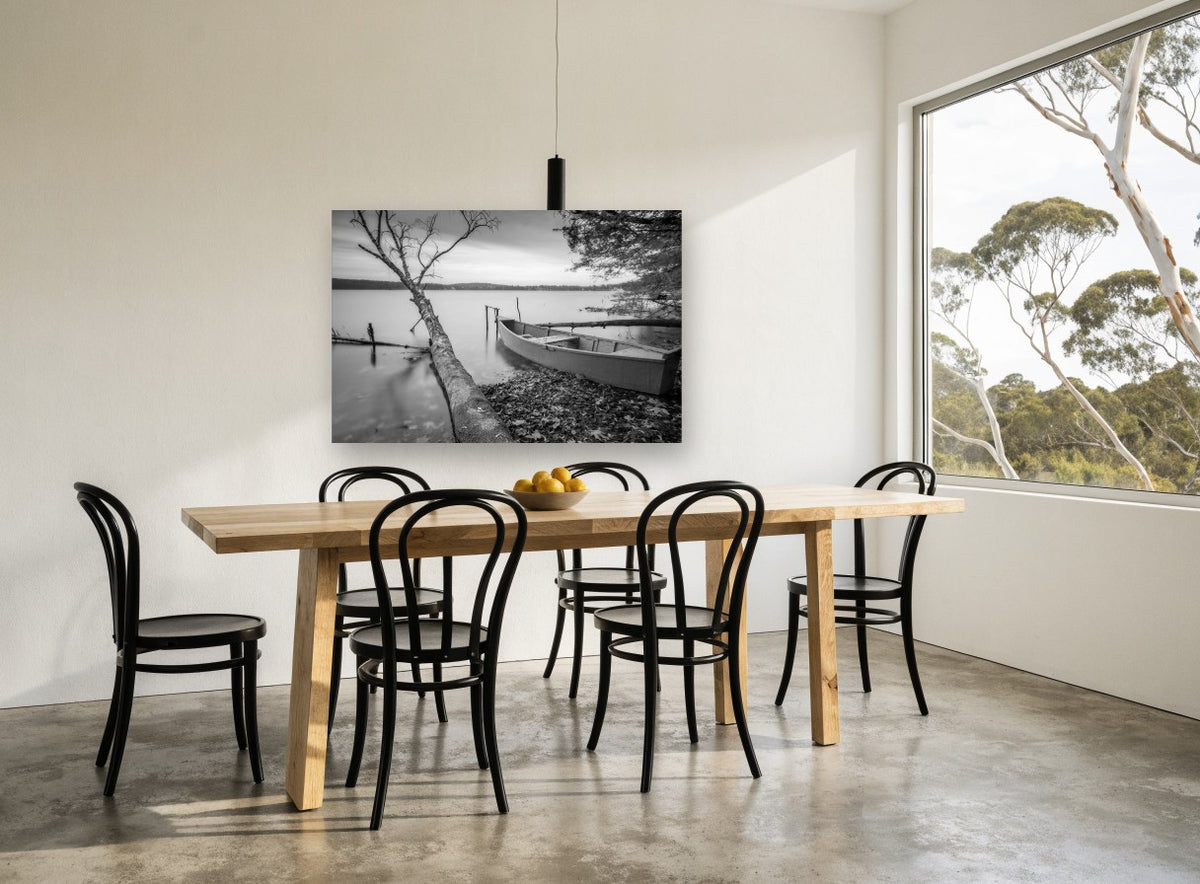 Still Shore Rowboat landscape canvas print on the wall of a dining room