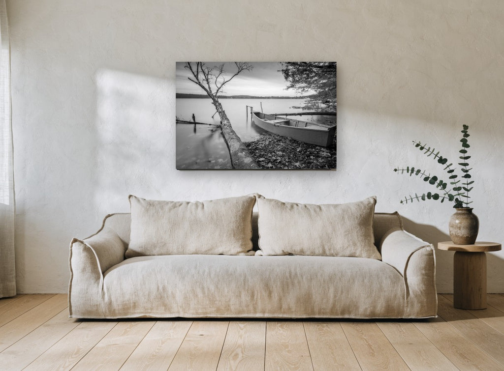 Still Shore Rowboat landscape canvas print on the wall of a living room