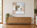 Palm Cove Patchwork coastal canvas print on the wall of a living room above a sideboard