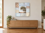 Palms and Patchwork Panels coastal canvas print on the wall of a living room above a sideboard