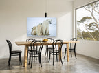 Arctic Family Huddle animal canvas print on the wall of a dining room
