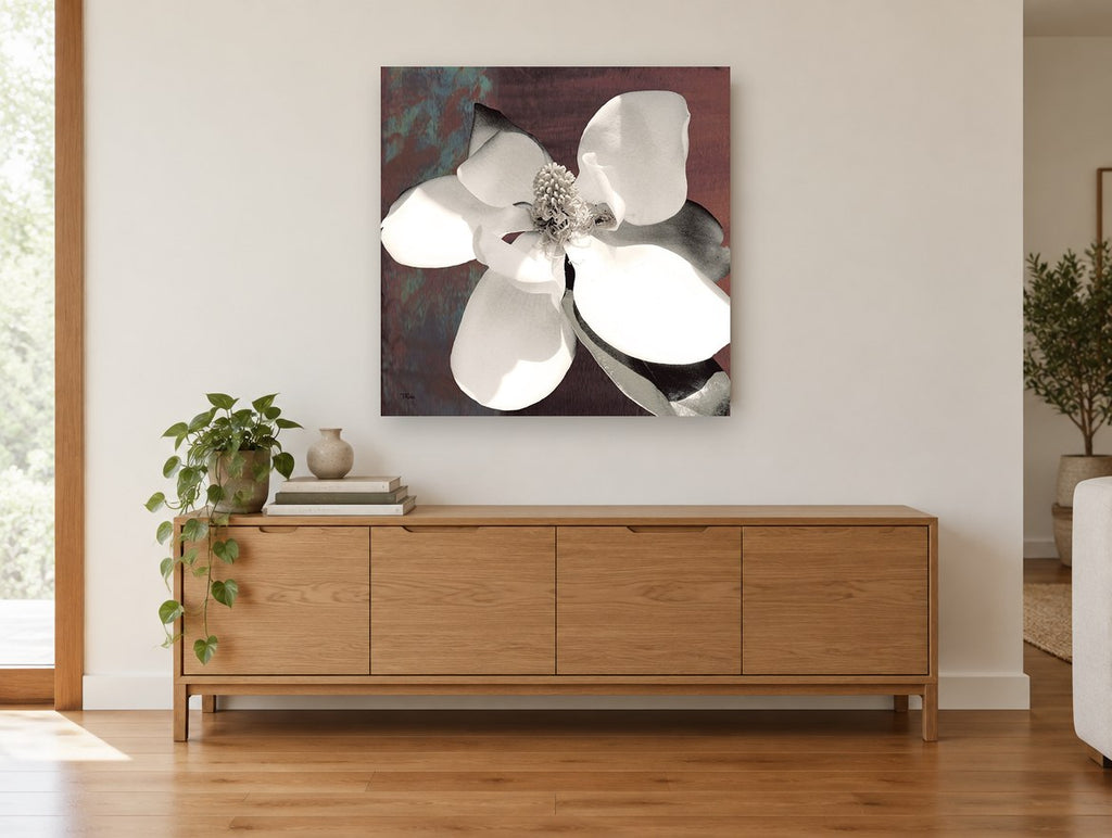 Open Magnolia on Rust floral canvas print on the wall of a living room above a sideboard