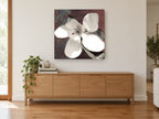 Open Magnolia on Rust floral canvas print on the wall of a living room above a sideboard