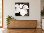 Open Cream Magnolia floral canvas print on the wall of a living room above a sideboard