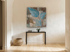 Blue Leaves on Linen floral canvas print on the wall of a hallway