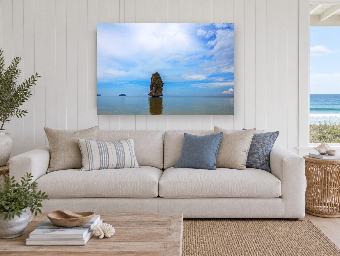Lone Sea Stack coastal canvas print on the wall of a beach house living room