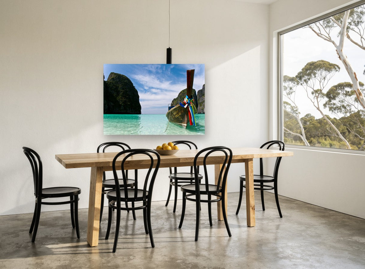Longtail Boat Lagoon coastal canvas print on the wall of a dining room