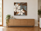 Cream Blooms on Chocolate floral canvas print on the wall of a living room above a sideboard