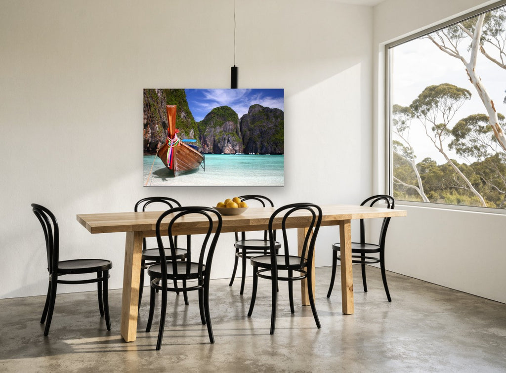Longtail Boat Lagoon coastal canvas print on the wall of a dining room