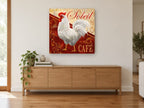 Soleil Café Rooster vintage canvas print on the wall of a living room above a sideboard