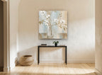 White Magnolia Stems in Glass floral canvas print on the wall of a hallway