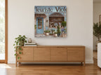 Blue Flower Shopfront floral canvas print on the wall of a living room above a sideboard