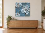 Blue Slate Blooms floral canvas print on the wall of a living room above a sideboard