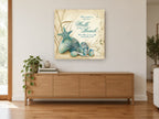 Teal Shells Beach Walk coastal canvas print on the wall of a living room above a sideboard