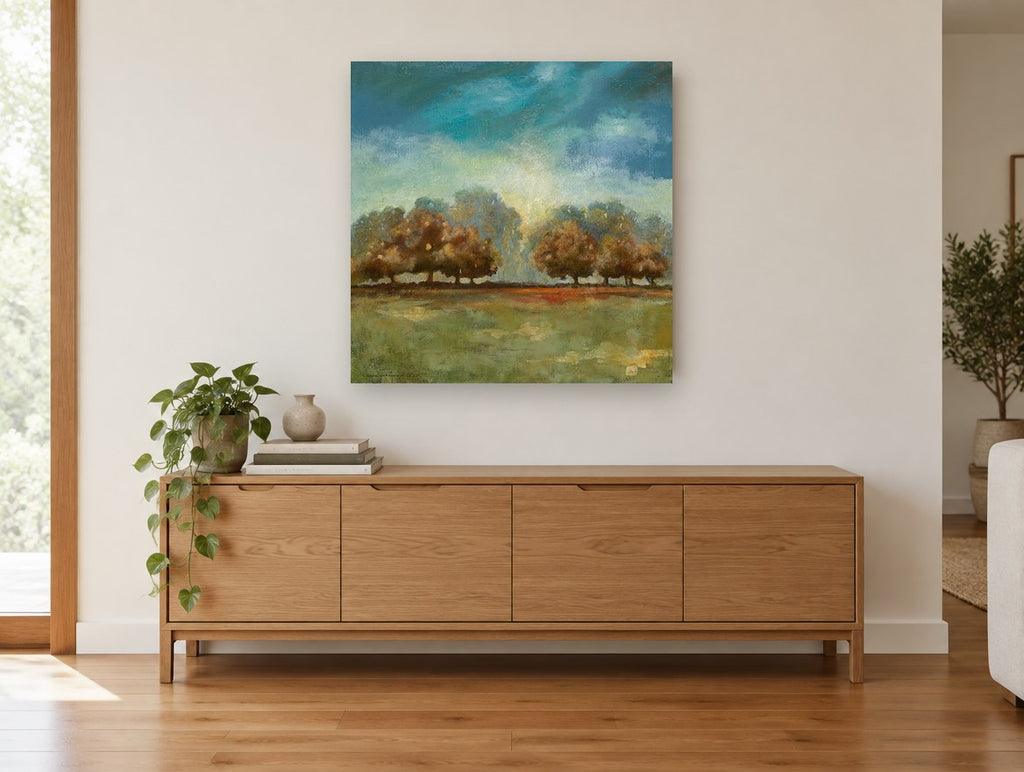 Teal Sky Meadow Trees landscape canvas print on the wall of a living room above a sideboard