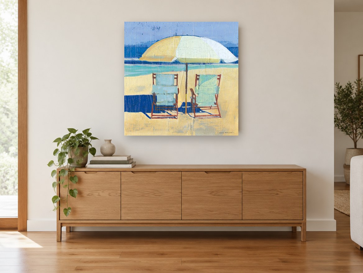 Two Chairs Beneath Umbrella coastal canvas print on the wall of a living room above a sideboard