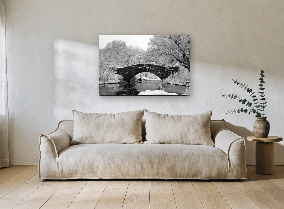 Snowbound Stone Arch city canvas print on the wall of a living room