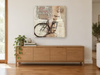 Bicycle Beneath the Empire State vintage canvas print on the wall of a living room above a sideboard