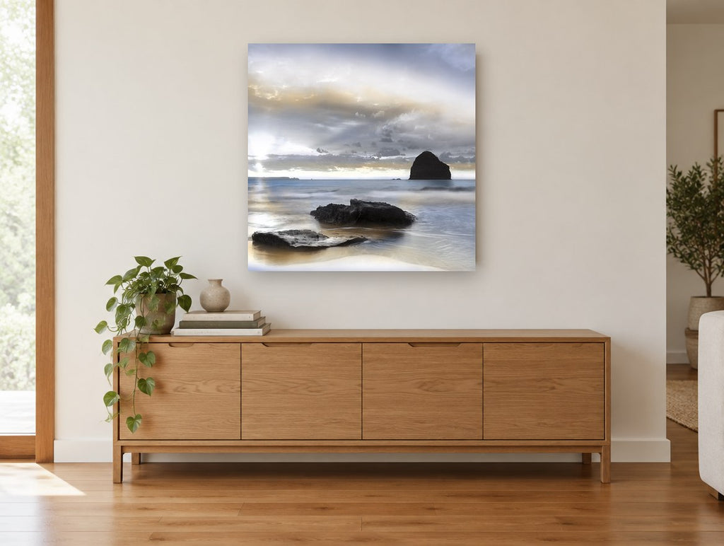 Silent Sea Stack coastal canvas print on the wall of a living room above a sideboard