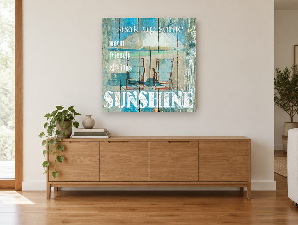 Sunshine Beach Chairs coastal canvas print on the wall of a living room above a sideboard