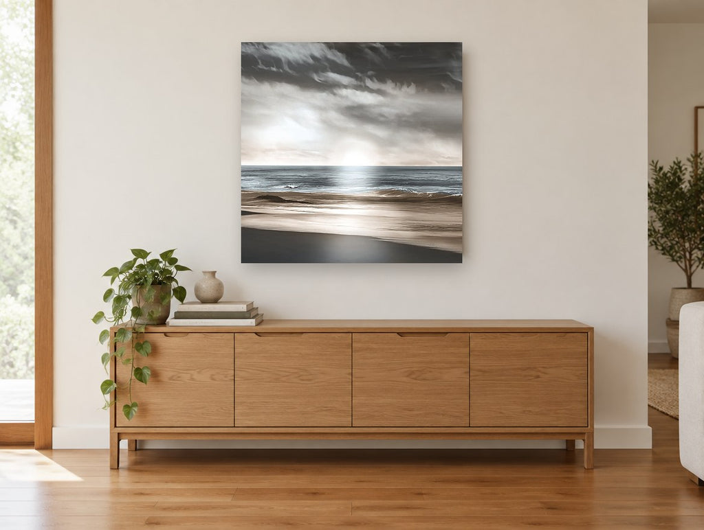Silver Light Shoreline coastal canvas print on the wall of a living room above a sideboard