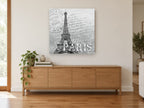 Paris Postmark Script vintage canvas print on the wall of a living room above a sideboard