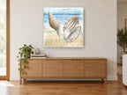 Newport Shells Beach coastal canvas print on the wall of a living room above a sideboard