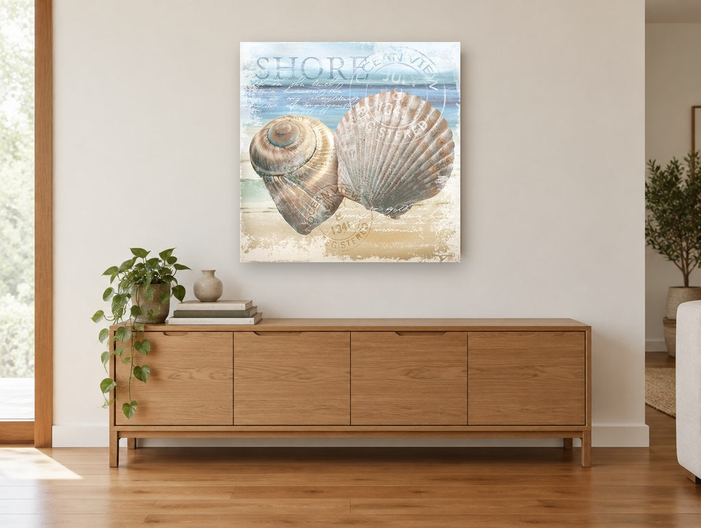 Shells on the Shore coastal canvas print on the wall of a living room above a sideboard