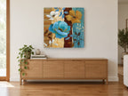 Teal and Gold Blooms floral canvas print on the wall of a living room above a sideboard
