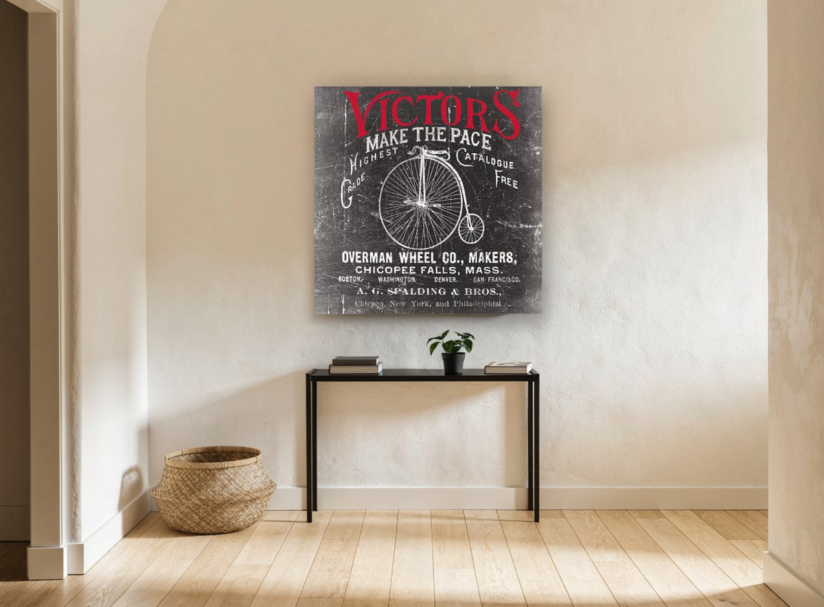 Victors Make the Pace vintage canvas print on the wall of a hallway