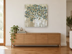 Teal Dot Tree landscape canvas print on the wall of a living room above a sideboard