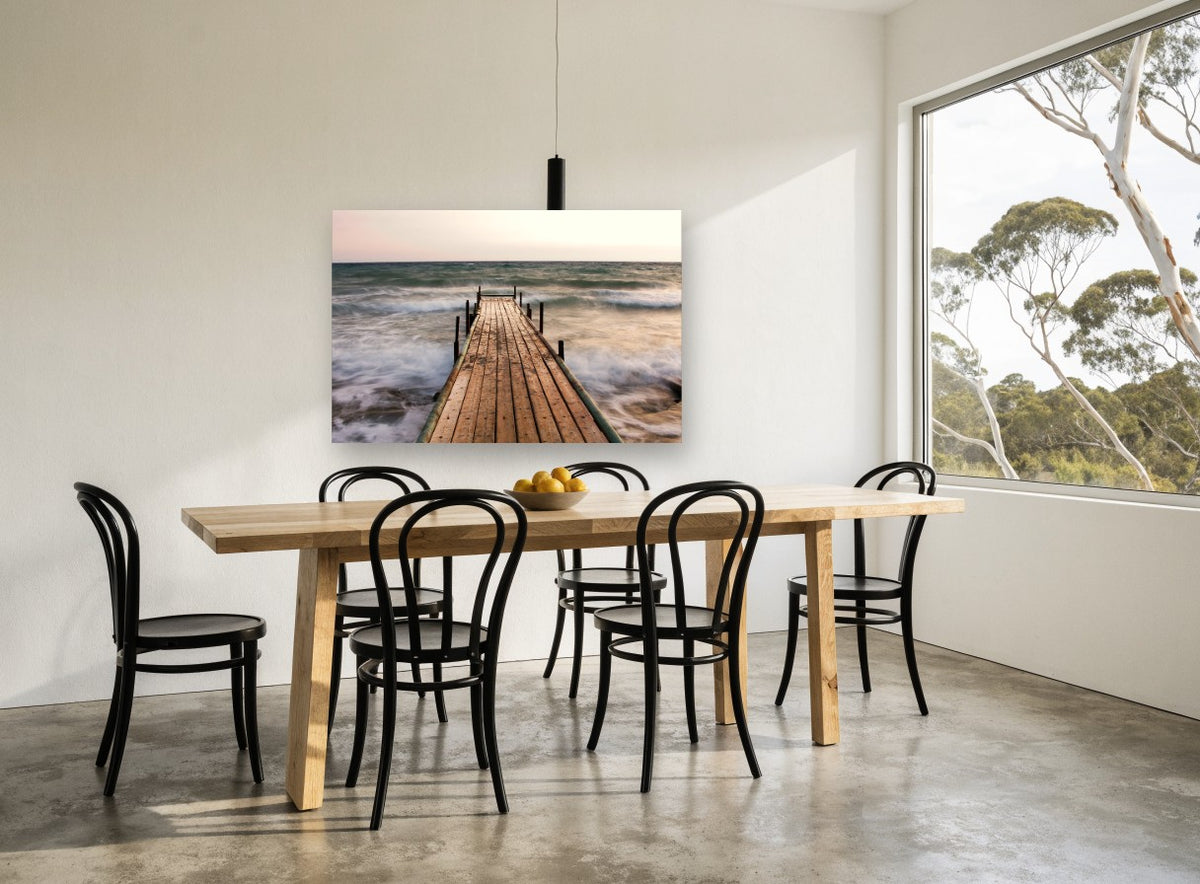 Jetty in the Surge coastal canvas print on the wall of a dining room