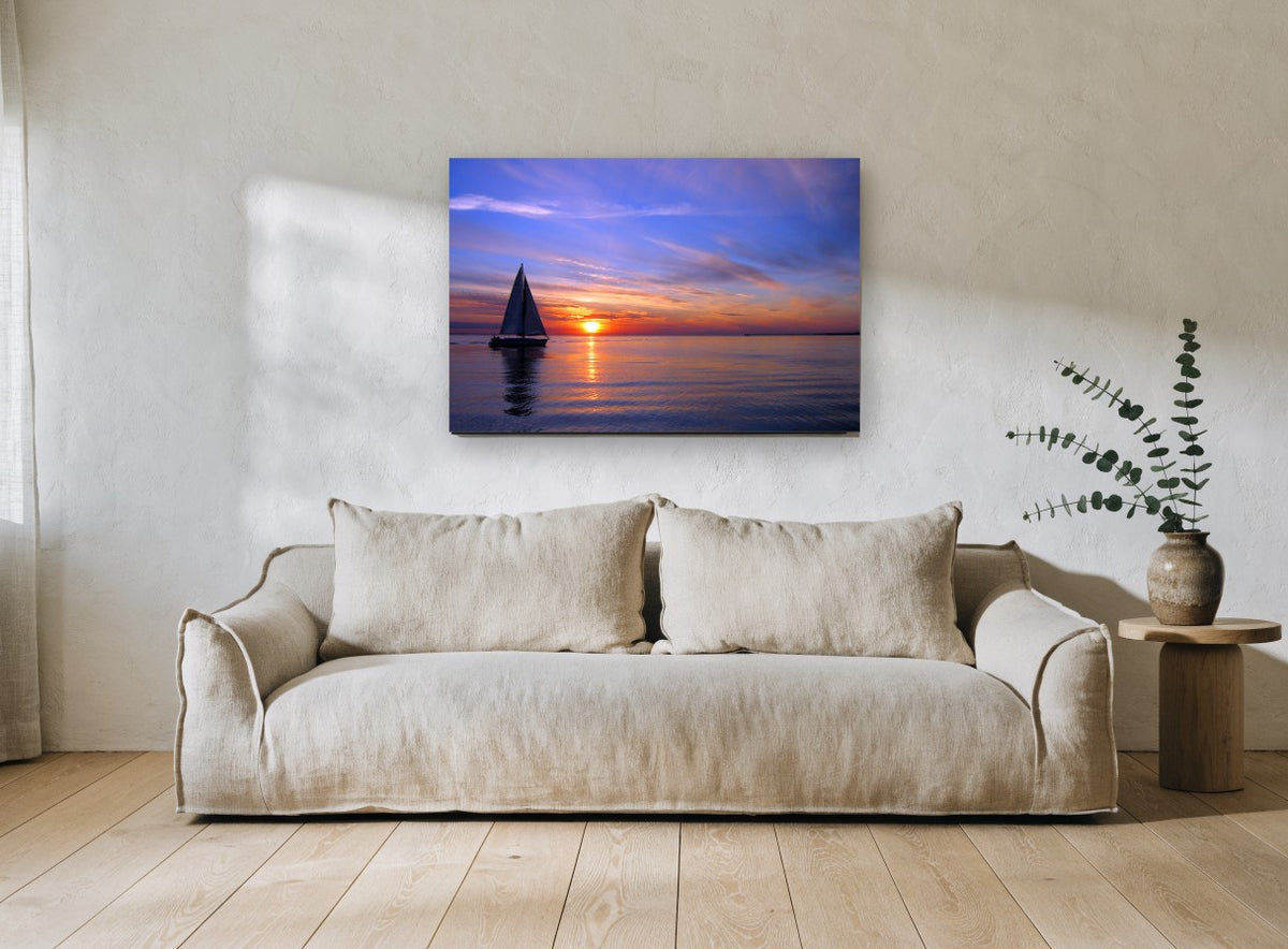 Sailing Into Dusk coastal canvas print on the wall of a living room