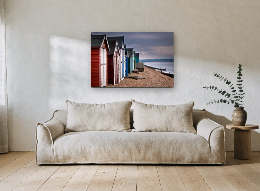 Stormlight Beach Huts coastal canvas print on the wall of a living room