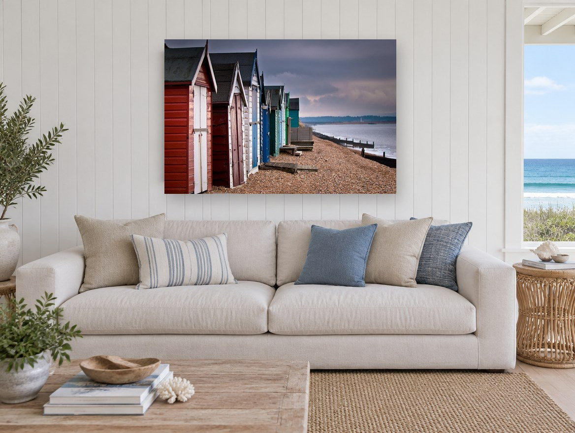 Stormlight Beach Huts coastal canvas print on the wall of a beach house living room