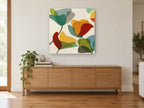 Overlapping Poppy Shapes floral canvas print on the wall of a living room above a sideboard