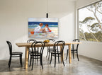 Sandcastle Sisters coastal canvas print on the wall of a dining room