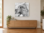 Splattered Zebra Pair animal canvas print on the wall of a living room above a sideboard