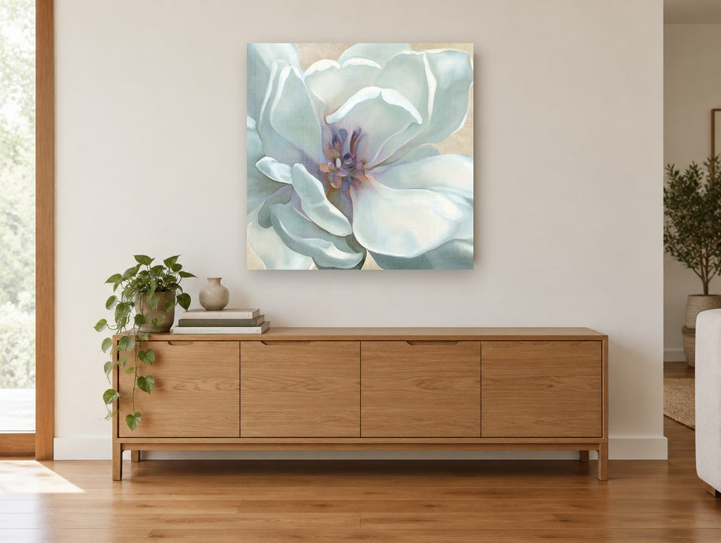 Pale Magnolia Bloom floral canvas print on the wall of a living room above a sideboard