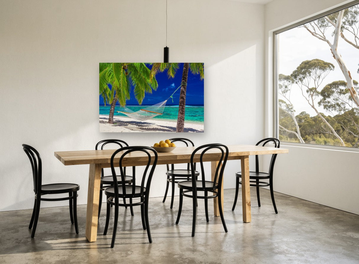 Hammock Between Palms coastal canvas print on the wall of a dining room