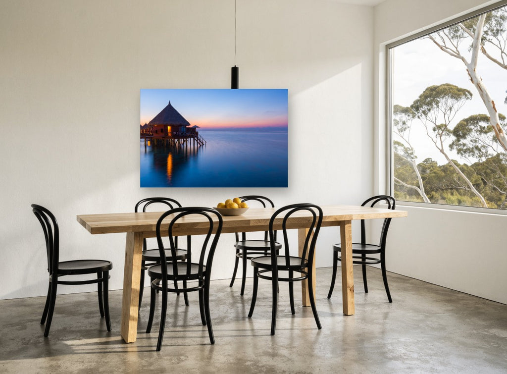 Dusk at the Water Bungalows coastal canvas print on the wall of a dining room