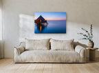 Dusk at the Water Bungalows coastal canvas print on the wall of a living room