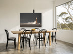 Storm Light Beacon coastal canvas print on the wall of a dining room