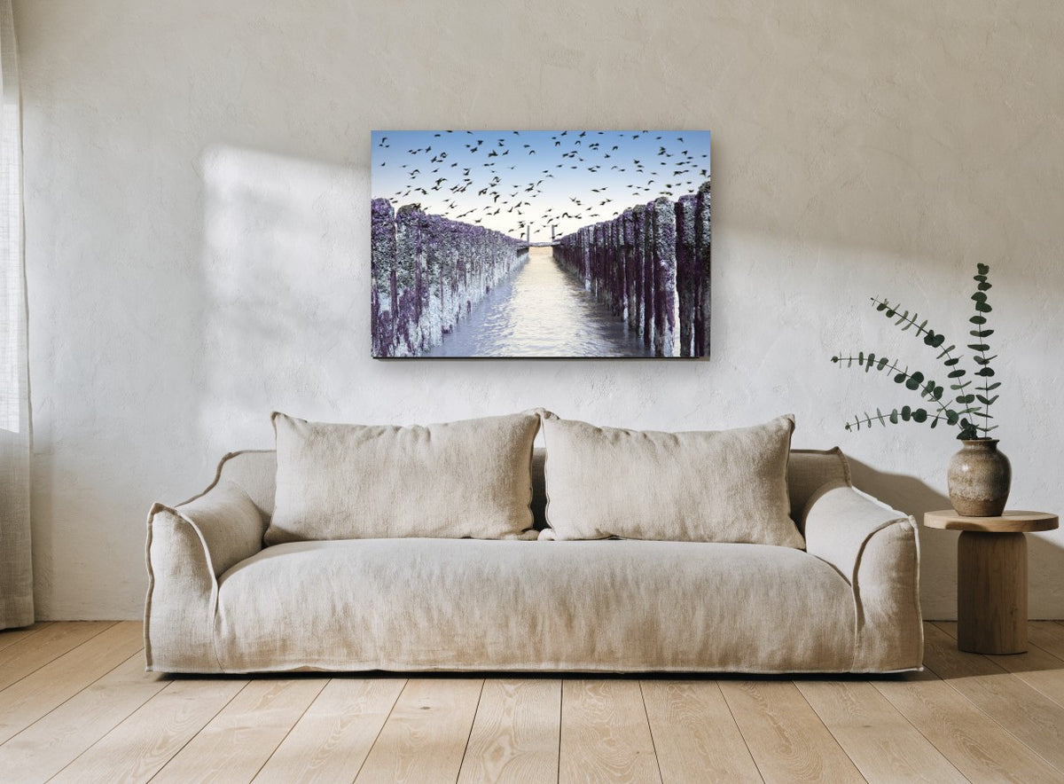 Birds Over Purple Groynes coastal canvas print on the wall of a living room