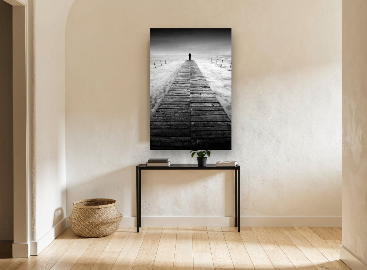 Lone Figure Jetty coastal canvas print on the wall of a hallway