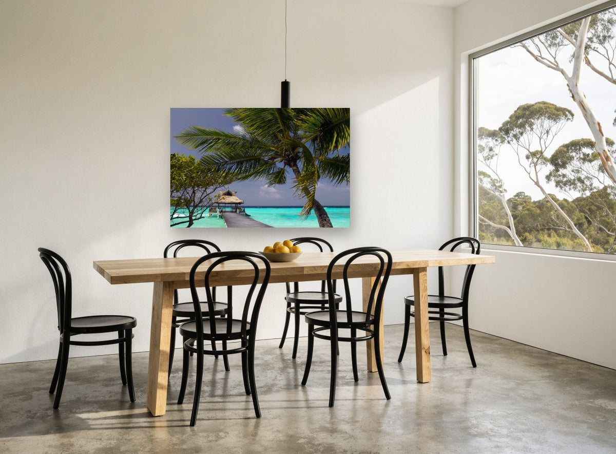 Palm Over the Jetty coastal canvas print on the wall of a dining room